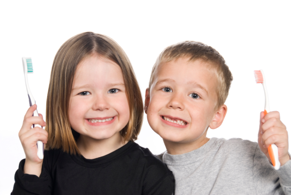 kids smiling with toothbrush